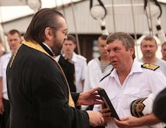 Отец Андрей вручает капитану Максиму Родионову икону Николая Чудотворца, освящённую в Храме Святого Николая.